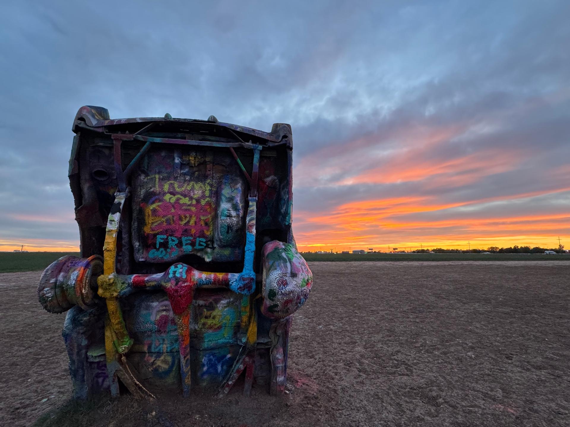 Spray-painted Cadillacs at sunset