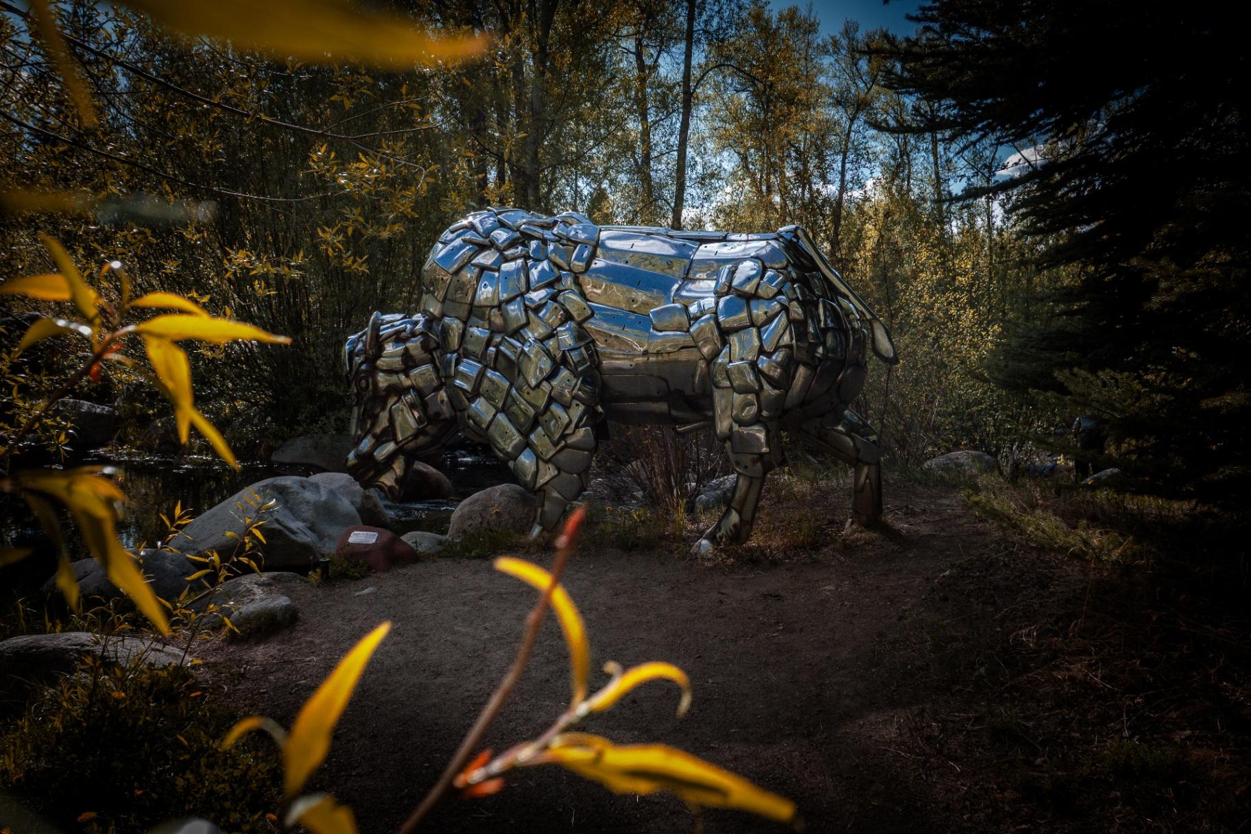Chrome bison sculpture by the river