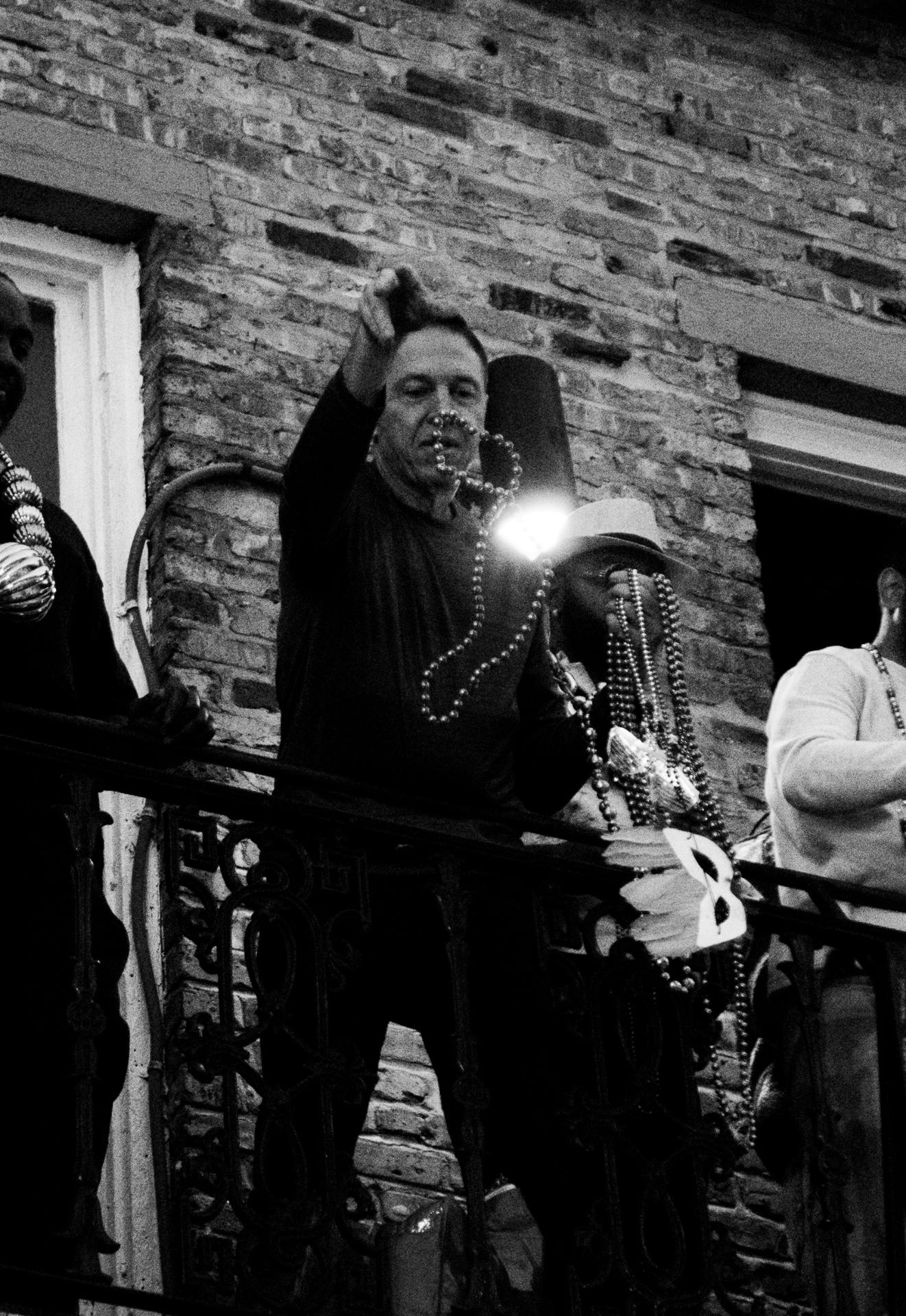 Beads on a French Quarter balcony at night